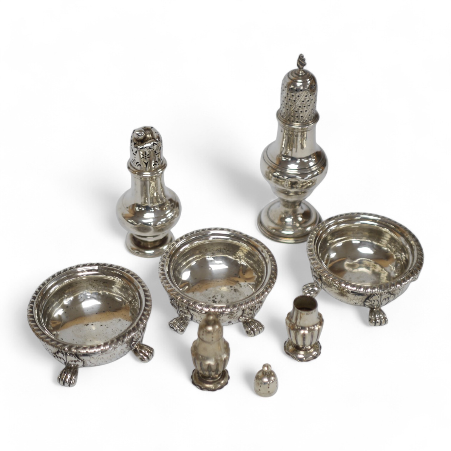 A set of three George IV silver circular salts, by Matthew Boulton Plate Co, diameter 86mm and four other later silver condiments, 14.7oz. Condition - poor